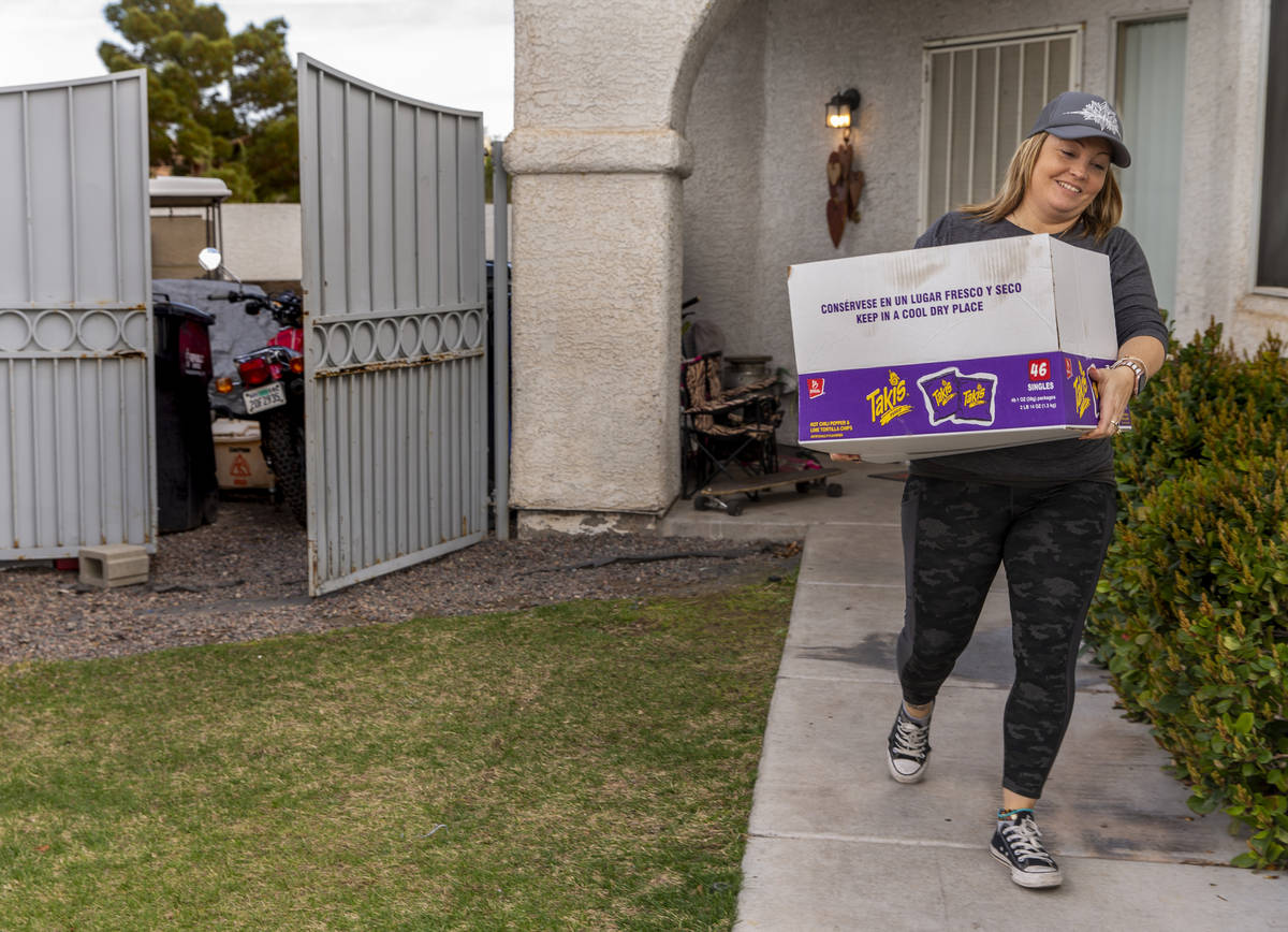 Kat Morris retrieves another donated box of food and supplies on her rounds with the COVID-19 B ...