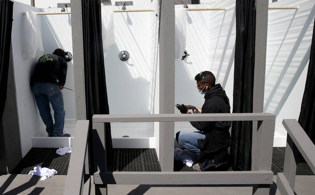 Workers prepare showers at the Cashman Isolation-Quarantine Complex in Las Vegas Monday, April ...