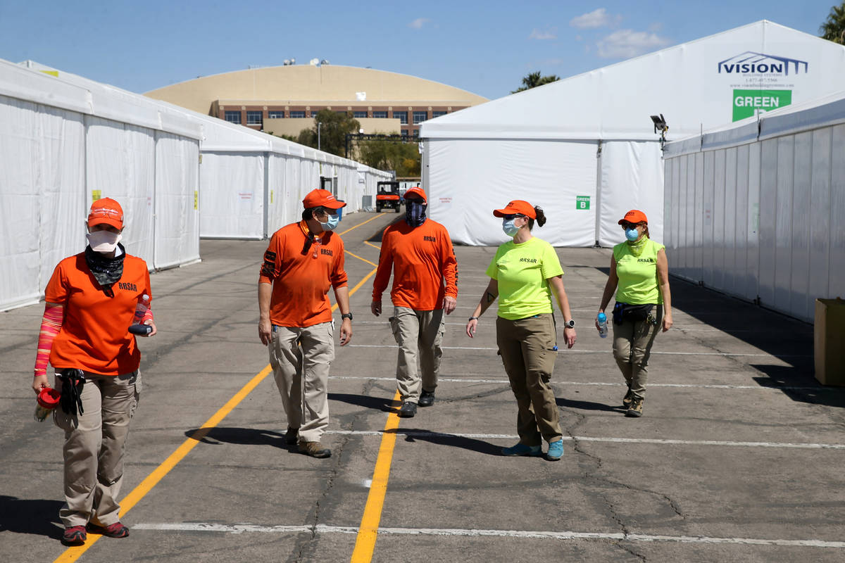 Volunteers with Red Rock Search and Rescue help set up the Cashman Isolation-Quarantine Complex ...