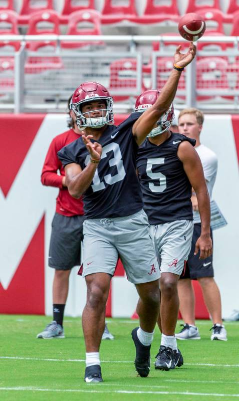 Alabama quarterback Tua Tagovailoa (13) works through drills in Alabama's fall camp fan-day col ...