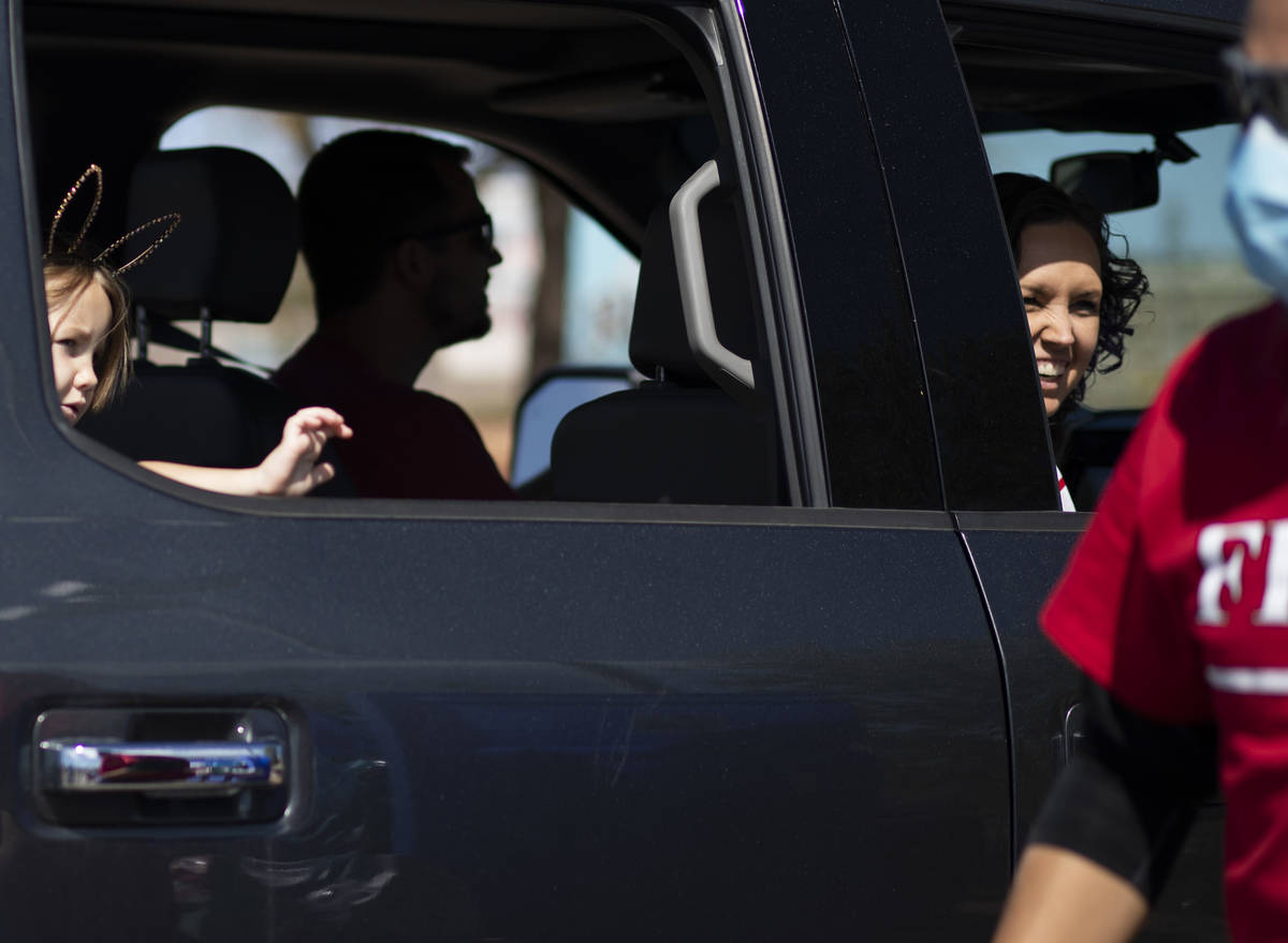A family picks up Easter baskets in a drive through at Mountain Ridge Park on Saturday, April 1 ...