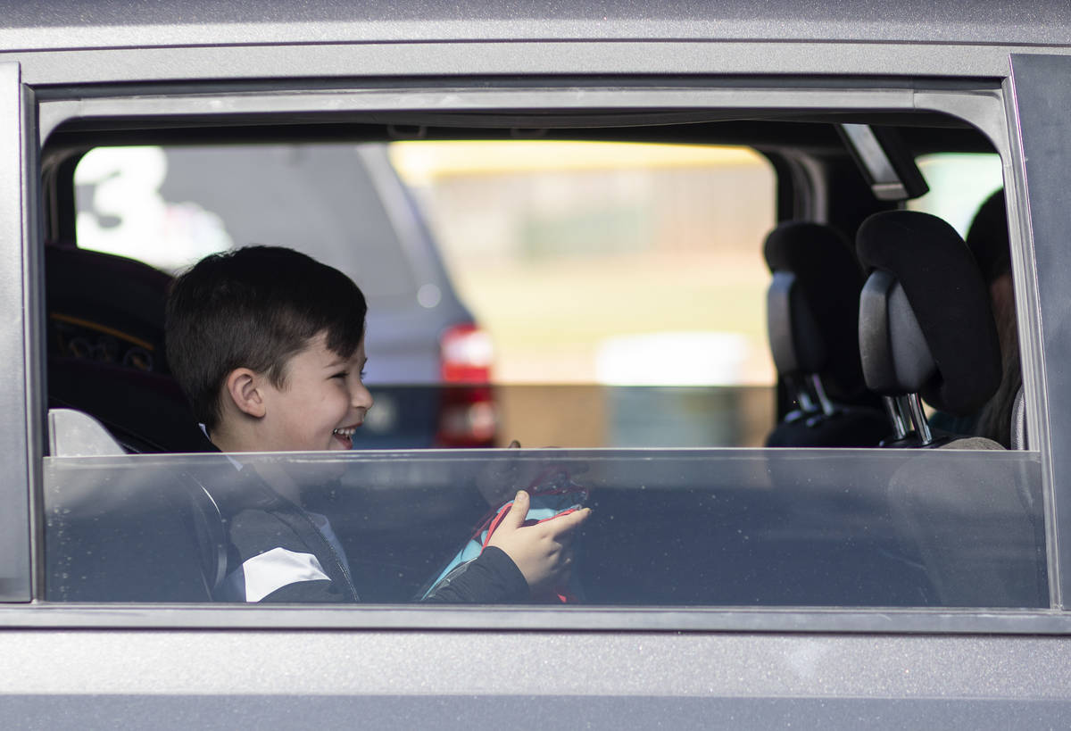 A boy smiles after receiving an Easter basket during a holiday drive through organized by Mayor ...