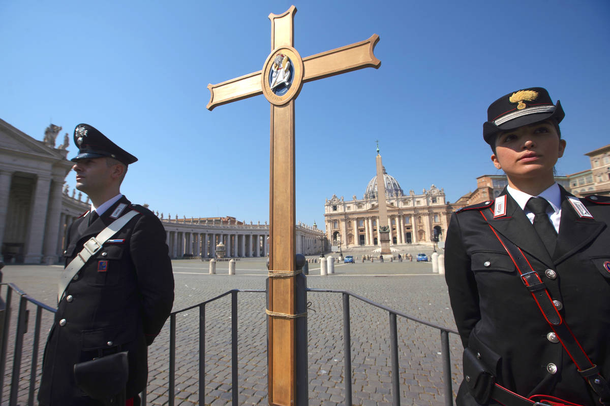 Italian Carabinieri stand by a cross, donated to them during the Holy Year of 2016, placed by a ...