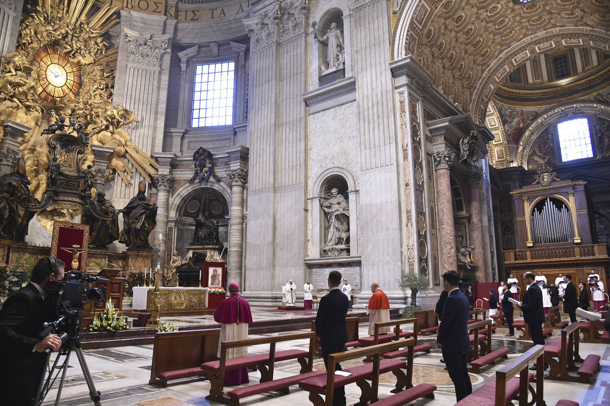 Few faithful attends Pope Francis', small white figure at center, Easter Sunday Mass, inside an ...