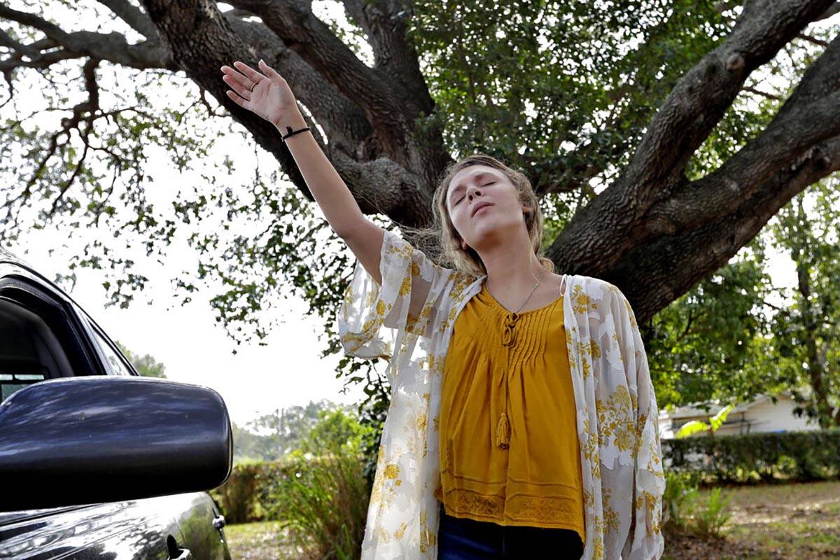 Victoria Cornell waves her arms in prayer during a drive in Easter service Sunday, April 12, 20 ...