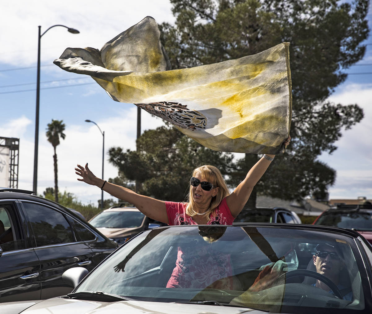 Pam Dunleavy waves a flag as she worships with her husband Dr. Sean Dunleavy at an Easter servi ...