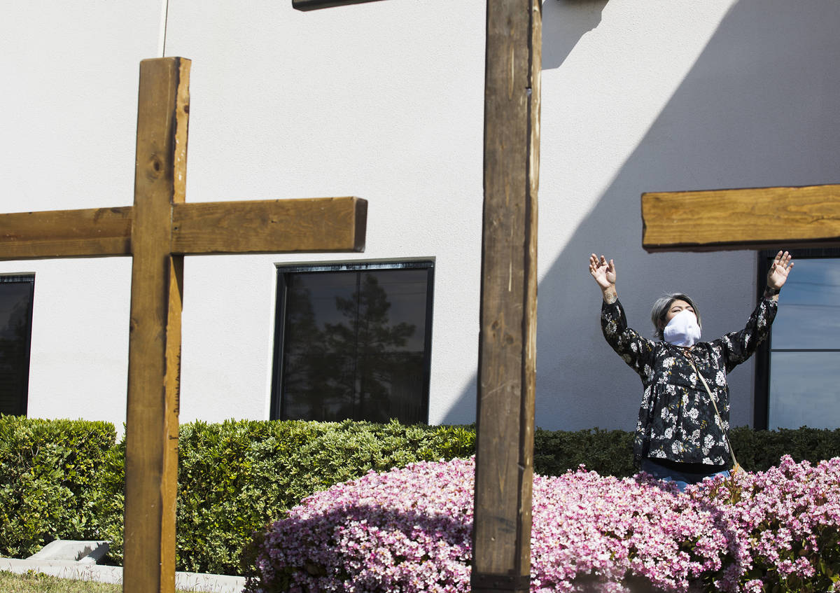Norma Urrabazo worships from the side of the stage at an Easter service in the parking lot at I ...