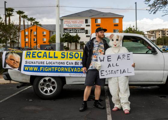 Cody Cunningham and Michelle Franco, in an Easter bunny costume, await the start of the Nevada ...