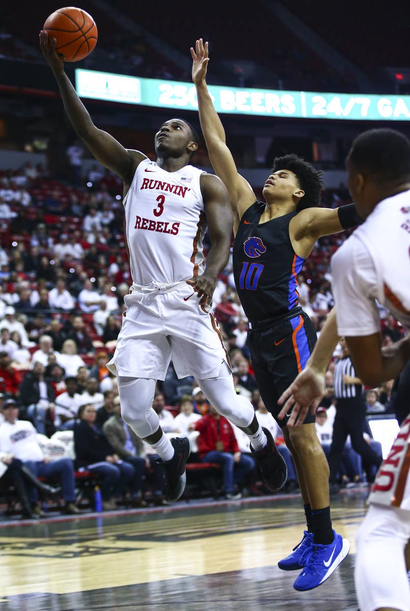 UNLV Rebels' Amauri Hardy (3) goes to the basket against Boise State Broncos' RayJ Dennis (10) ...