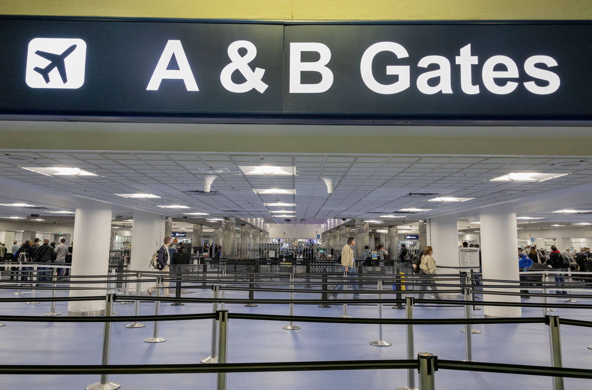 Passengers enter a security queue at McCarran International Airport in Las Vegas on Thursday, M ...