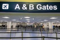 Passengers enter a security queue at McCarran International Airport in Las Vegas on Thursday, M ...