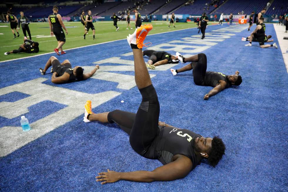 Louisville offensive lineman Mekhi Becton stretches at the NFL football scouting combine in Ind ...