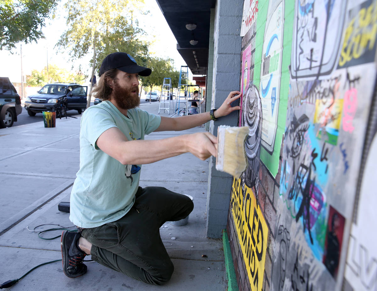 Artist Izaac Zevalking (aka: Recycled Propaganda) creates art on boards covering windows at his ...