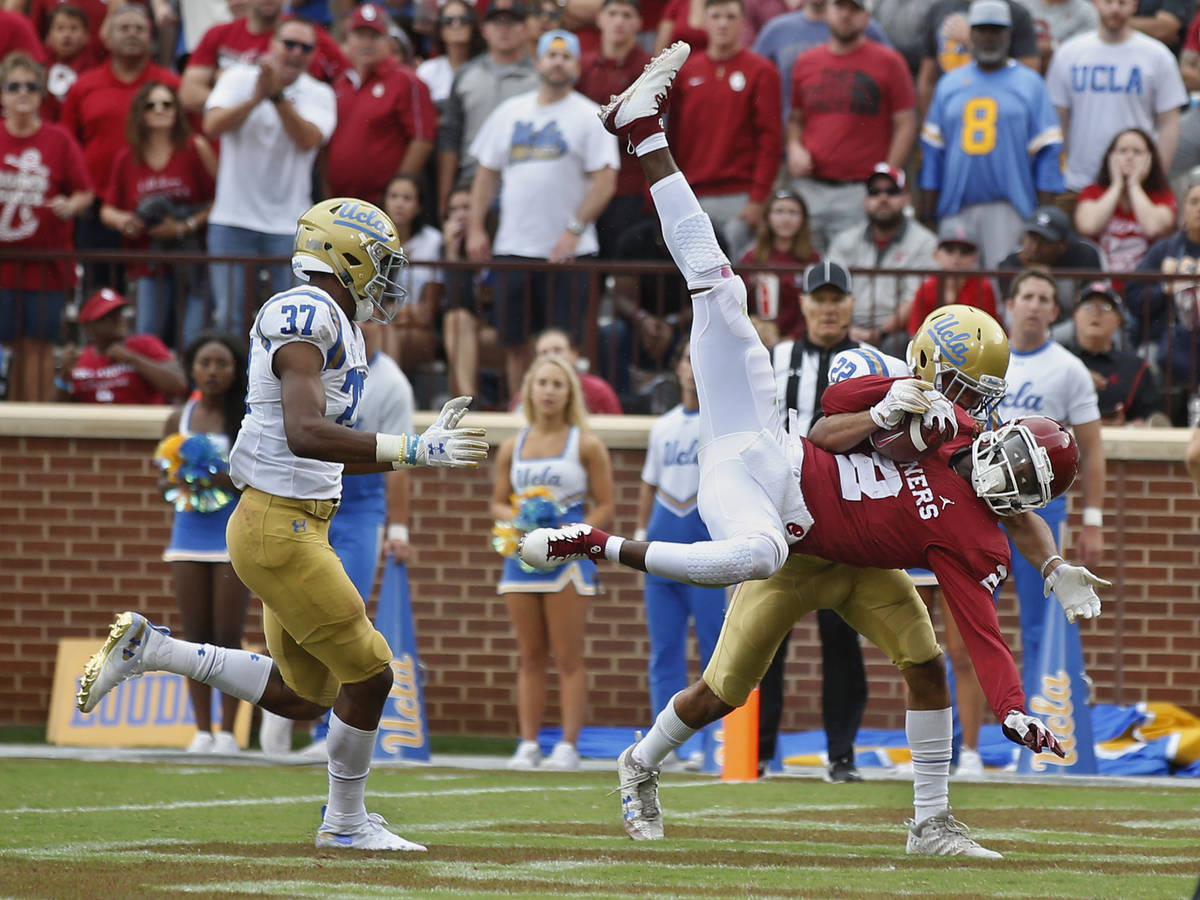 Oklahoma wide receiver CeeDee Lamb (2) comes down with a touchdown pass in front of UCLA defens ...