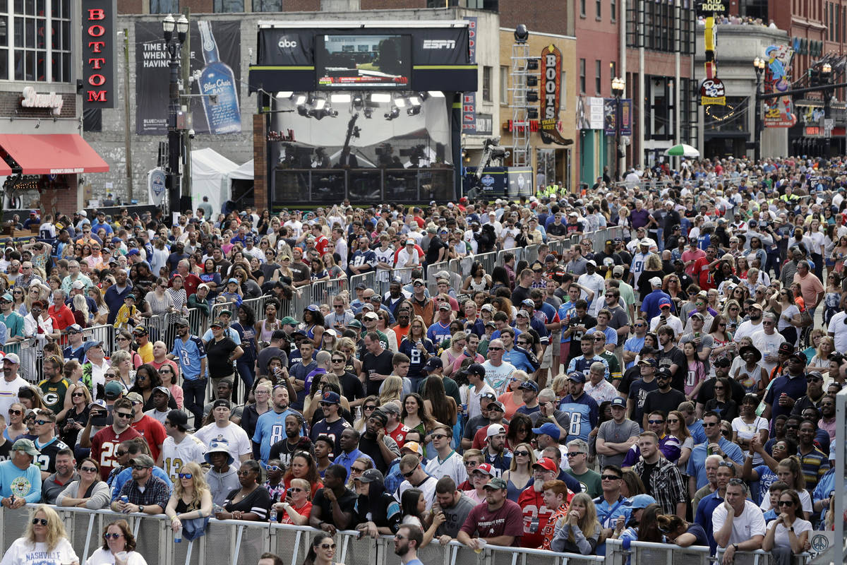 FILE - In this April 27, 2019, file photo, fans attend the final day of the NFL football draft ...