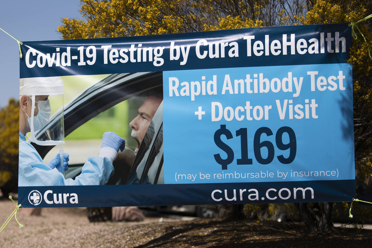 A sign advertising drive-through COVID-19 antibody testing is displayed outside PAM Speciality ...