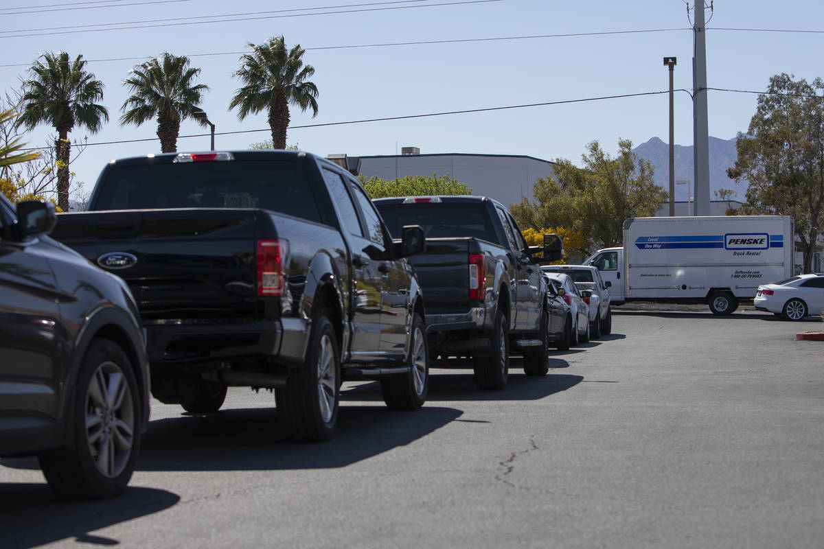 Cars line up for drive-through COVID-19 antibody testing, which took place out of the back of a ...