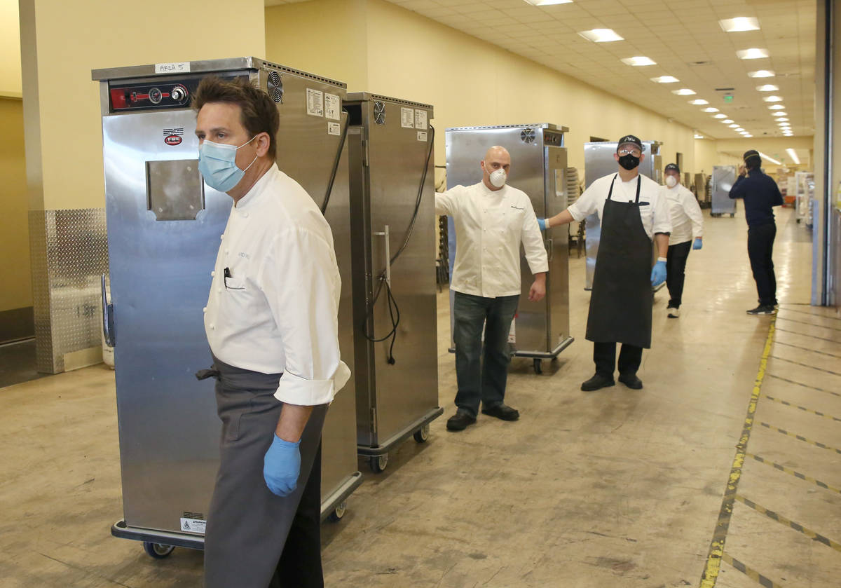 David Werly, front, executive chef at Aria hotel-casino, and other chefs prepare to load hot me ...