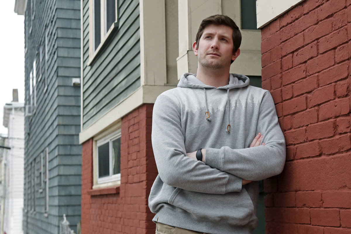 Cameron Karosis, 27, a software salesman, poses for a portrait outside his home, Tuesday, April ...
