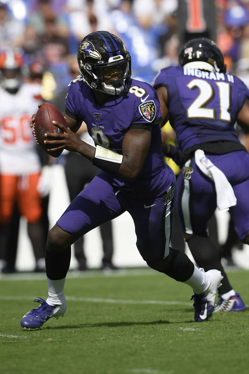 Baltimore Ravens quarterback Lamar Jackson (8) drops back during the second half of an NFL foot ...