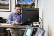 Attorney Michael Cahill makes a call to a client at his law office in Las Vegas, Friday, April ...