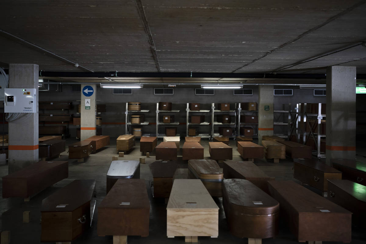 In this April 14, 2020, photo, coffins carrying the bodies of COVID-19 victims waiting to be bu ...