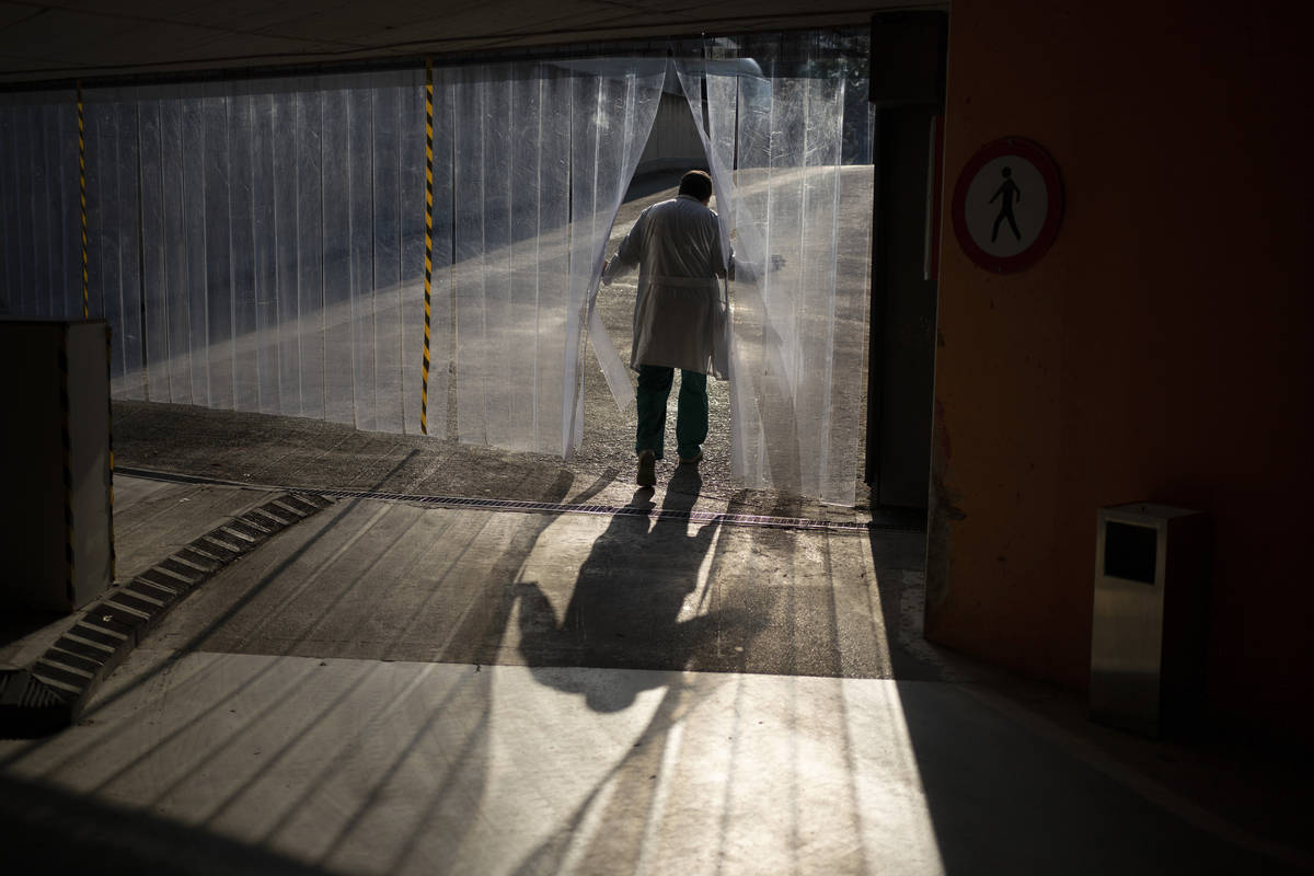 In this April 14, 2020, photo, head mortician Jordi Fernandez walks out of an underground parki ...