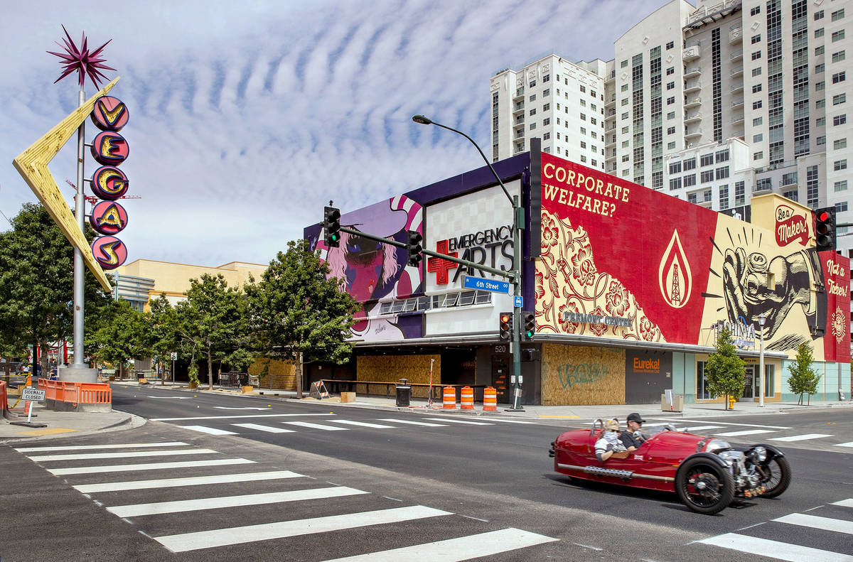 A couple motors along an empty Fremont Street in Downtown Las Vegas during the novel coronaviru ...