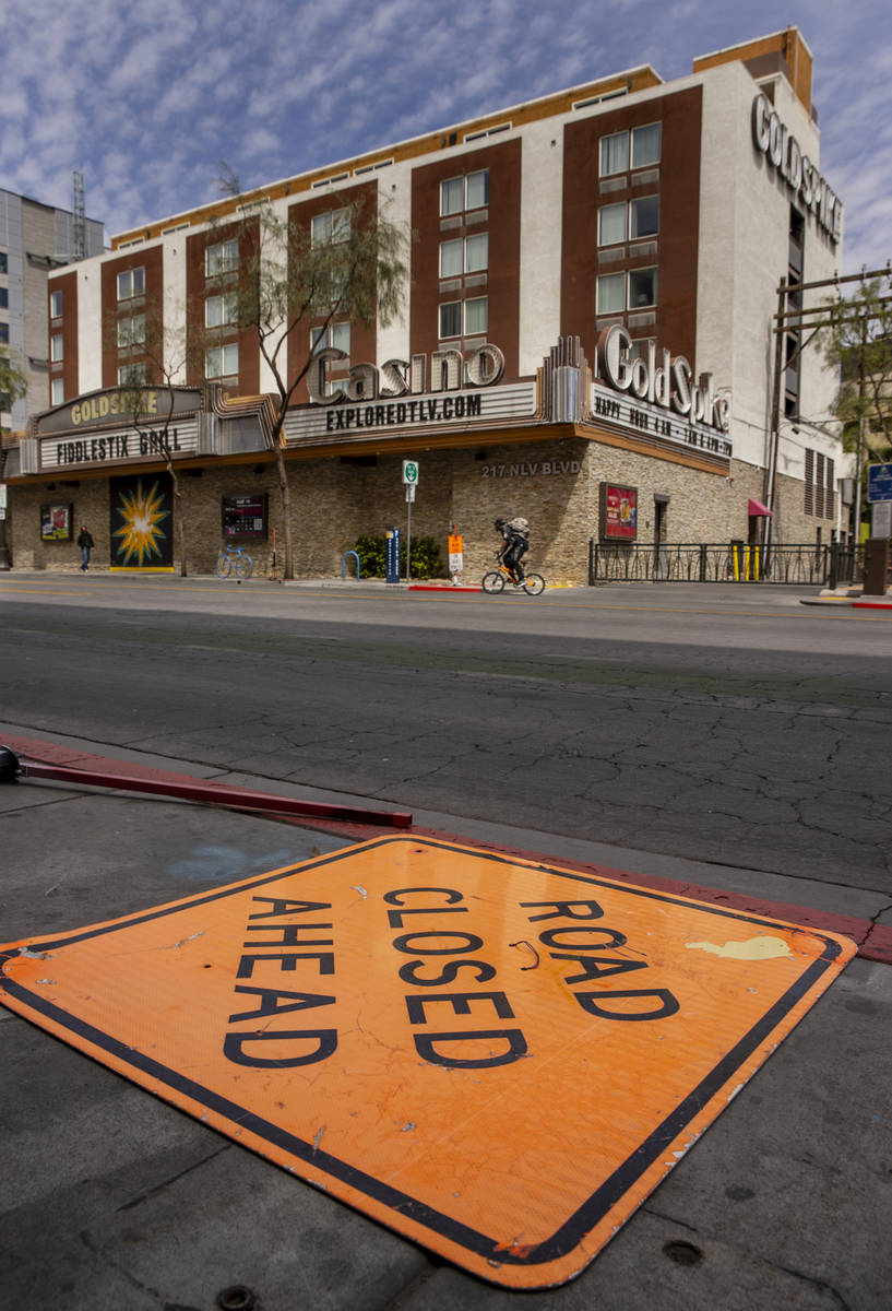 A cyclist rides past the Gold Spike along a quiet E. Ogden Avenue in Downtown Las Vegas during ...