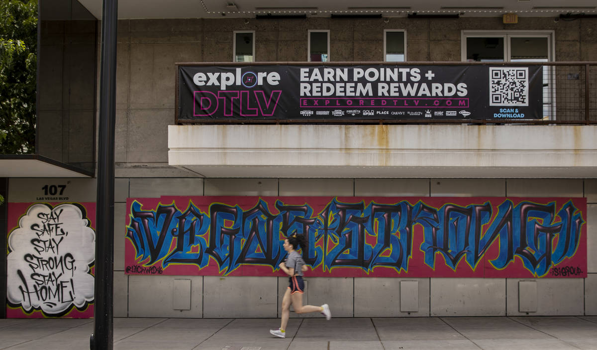 A runner cruises along an empty Fremont Street in Downtown Las Vegas during the novel coronavir ...