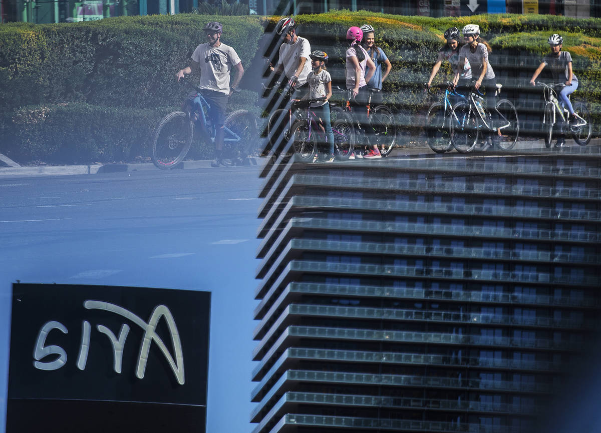 A large group of bicyclists wait at a light across from Aria on the Strip on Thursday, April 1 ...