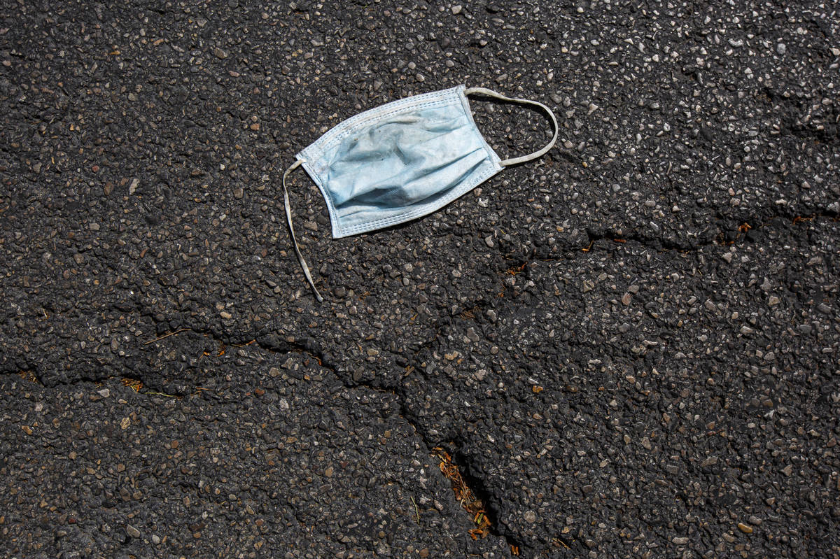A discarded surgical mask rests on the Las Vegas Strip on Thursday, April 16, 2020. (Chase Stev ...