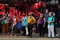 People wearing face masks to help protect themselves from contracting the coronavirus COVID-19 ...