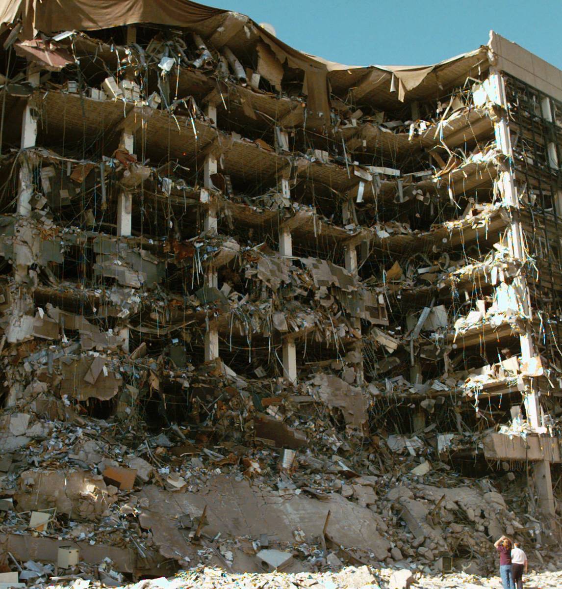 FILE-- In this April 19, 1995, file photo, rescue workers stand in front of the Alfred P. Murra ...