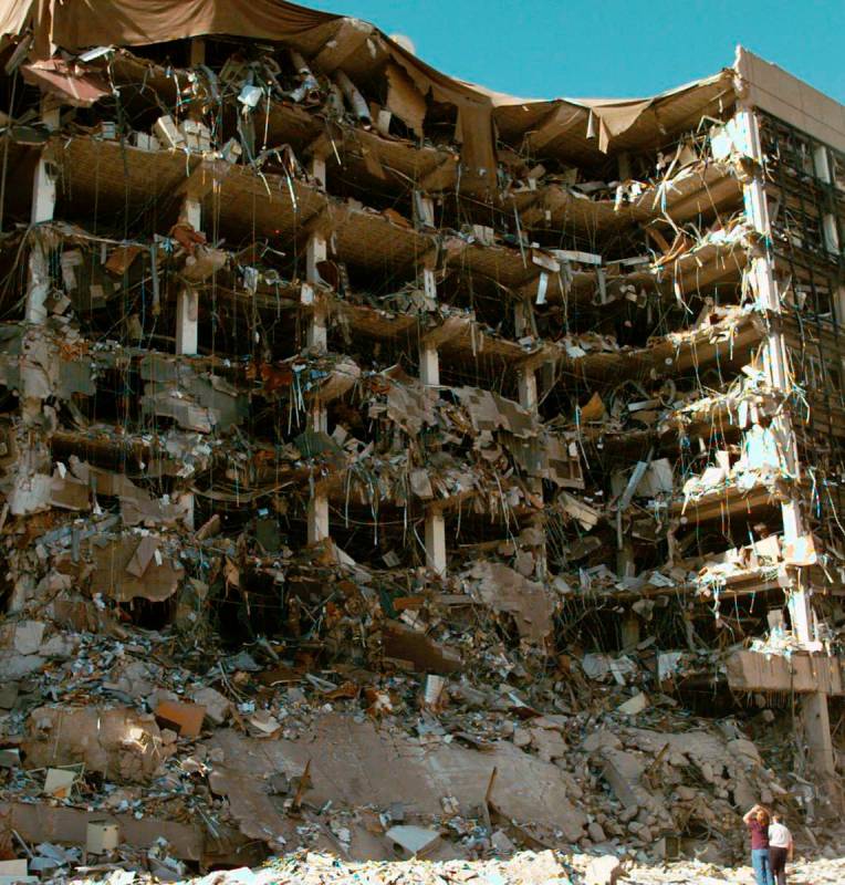 FILE-- In this April 19, 1995, file photo, rescue workers stand in front of the Alfred P. Murra ...
