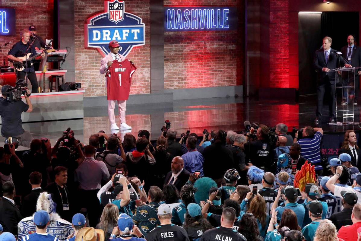 Oklahoma quarterback Kyler Murray shows off his new jersey after the Arizona Cardinals selected ...