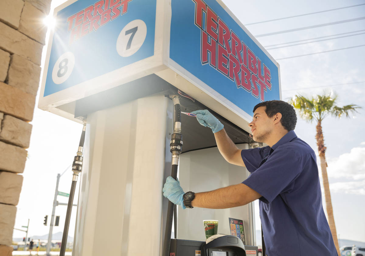 Terrible Herbst employee Bailey Baltins sanitizes gas pumps at Terrible Herbst on St. Rose Pkwy ...