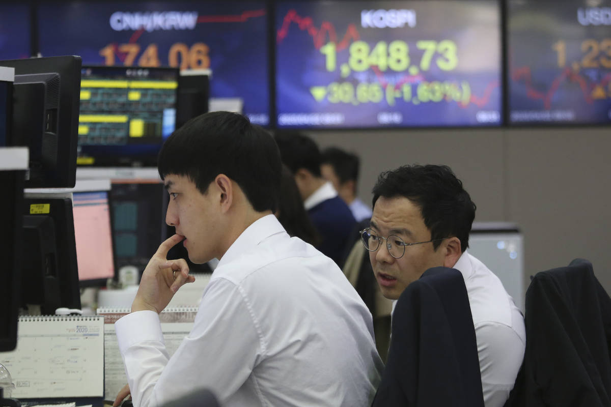 Currency traders watch monitors at the foreign exchange dealing room of the KEB Hana Bank headq ...
