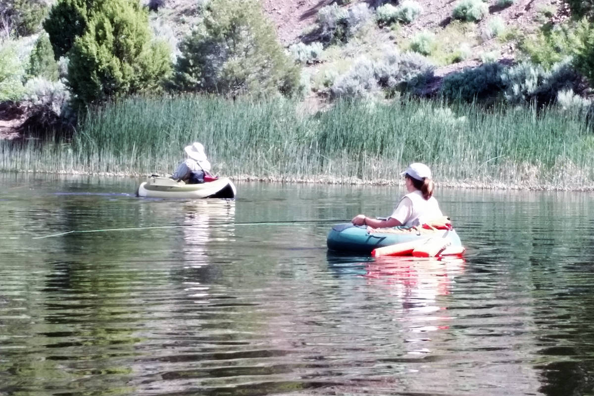 A pair of fly-fishers maintain safe fishtancing while float tubing at Eagle Valley Reservoir be ...