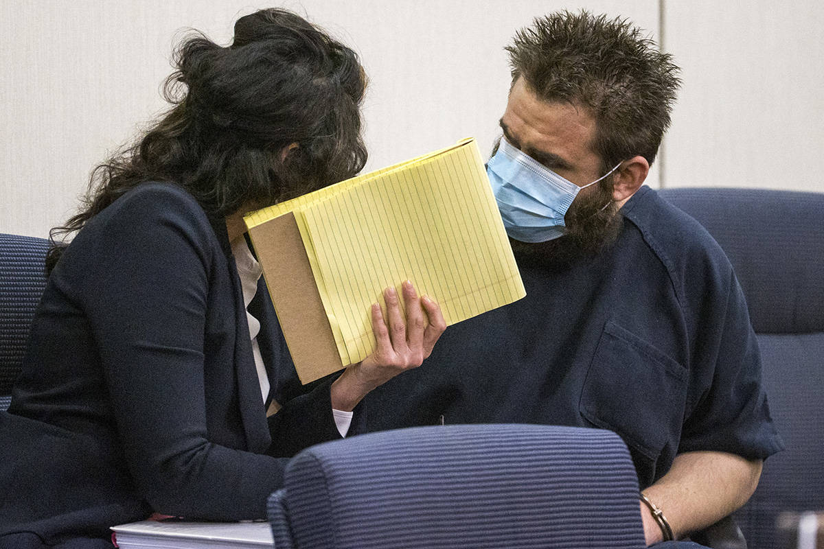 Joshua Nichols, right, confers with his lawyer Julie Raye during his hearing at Henderson Justi ...