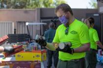 Bryce McCandless, a staff member at the Las Vegas Council of the Boy Scouts, sorts through dona ...