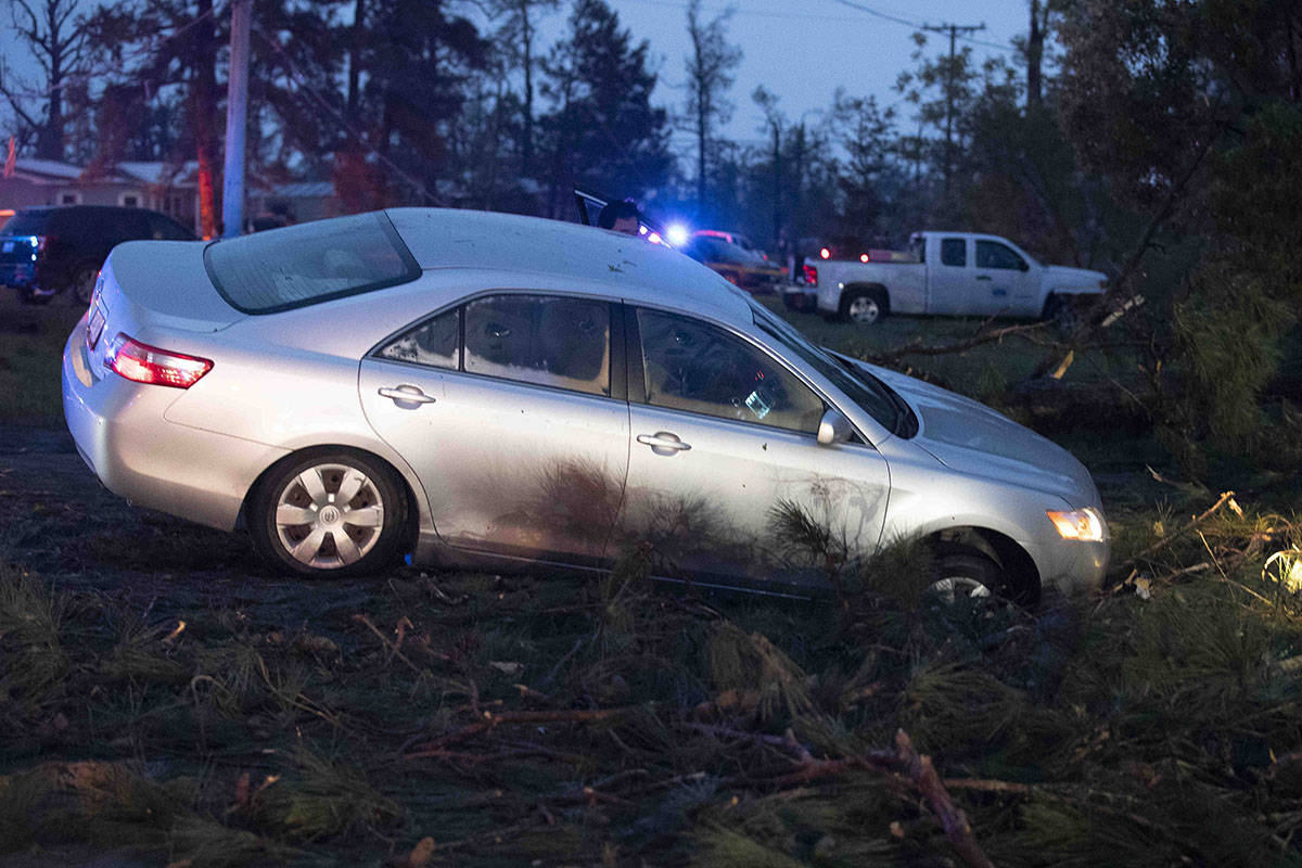 A car is seen in a ditch in Onalaska, Texas, after a tornado touched down in the area Wednesday ...