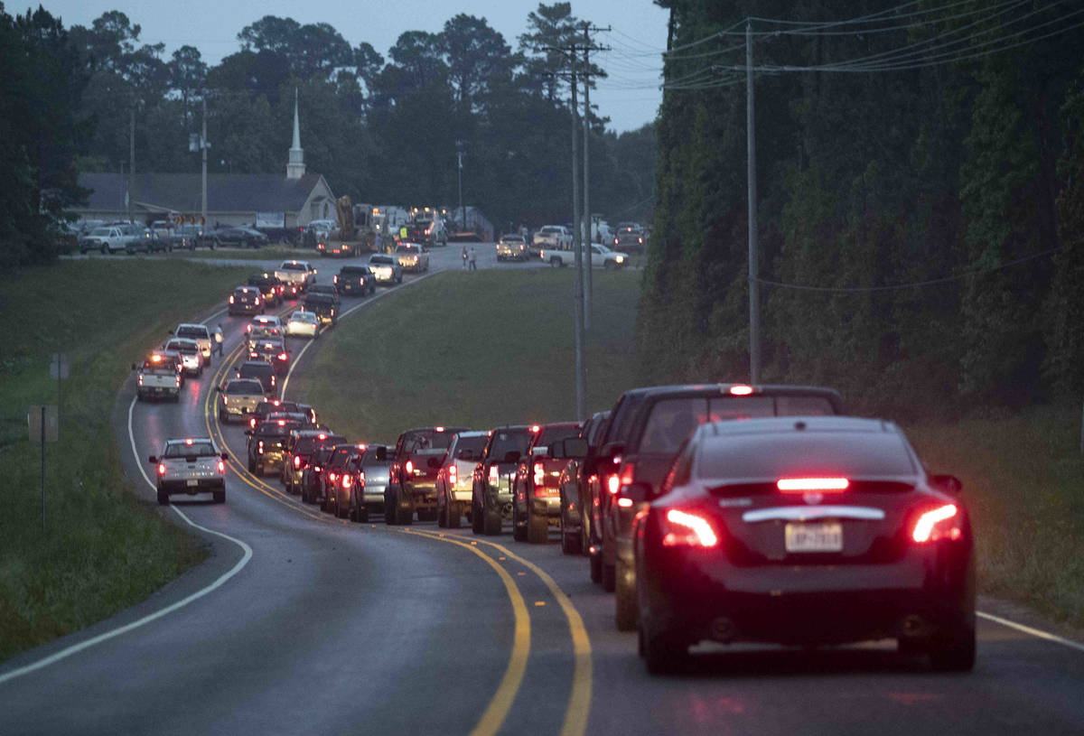 A line of vehicles is seen along FM 3459 in Onalaska, north of Houston, after a tornado touched ...