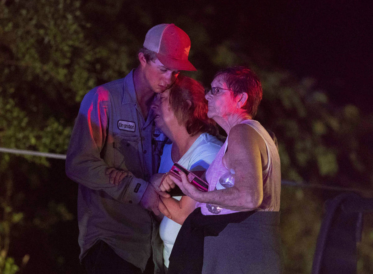 People embrace after an apparent tornado touched down Wednesday, April 22, 2020, in Onalaska, T ...