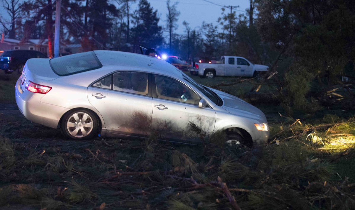 A car is seen in a ditch in Onalaska, Texas, after a tornado touched down in the area Wednesday ...