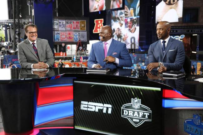 From left, Mel Kiper Jr., Booger McFarland, and Louis Riddick are seen on the set of ESPN Sport ...
