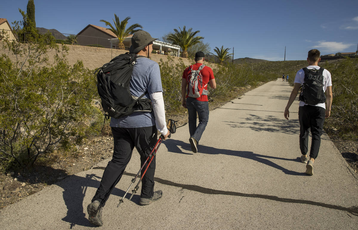 David Koch, left, with brother Michael and son Mason begin a trek back up to their Nevada light ...