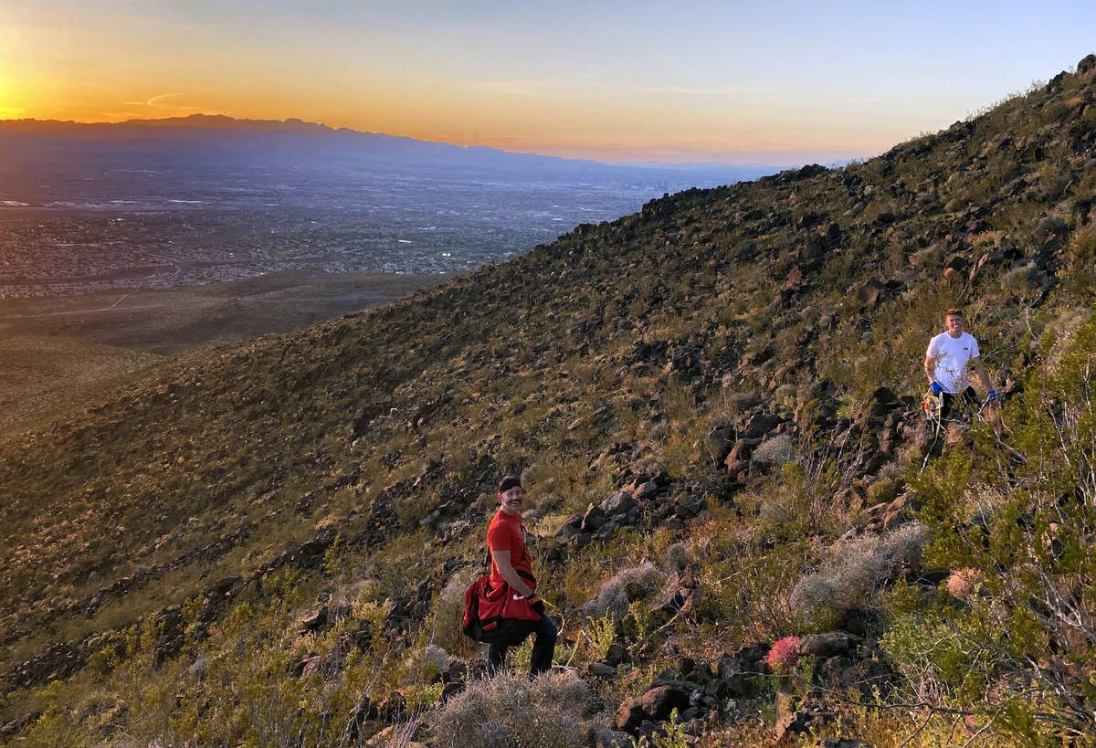 Michael, left, and Mason Koch atop of Black Mountain readjusting the heart within the Nevada li ...