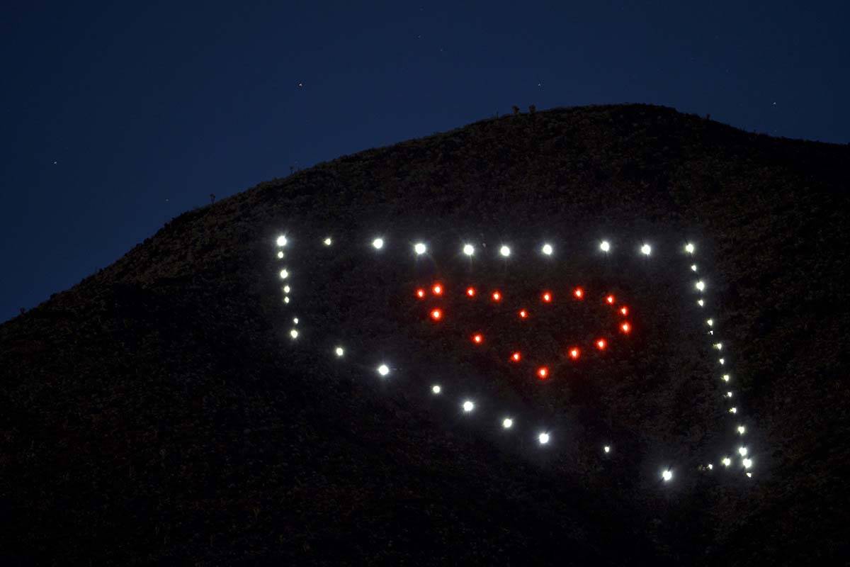 The solar lights shine brightly night falls about a Nevada light display atop of Black Mountain ...