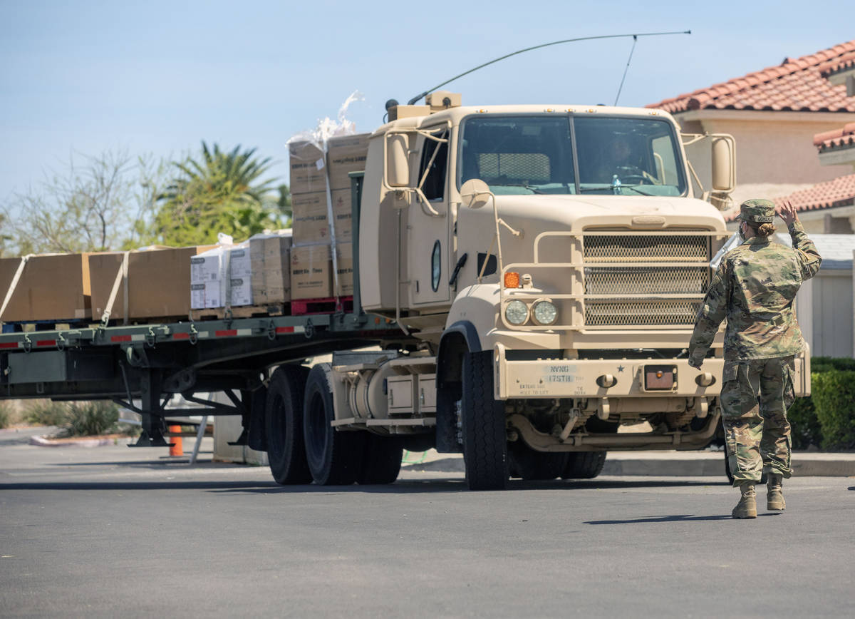 Nevada National Guard Sgt. Vanessa Gonzales directs a load of personal protective equipment arr ...
